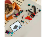 A child building the LEGO Minecraft 21279 The Enderman Tower set with digital instructions on a tablet.