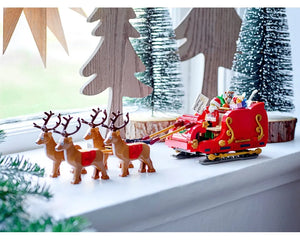 LEGO Santa's Sleigh (40499) with Santa, red sleigh, gifts, and four reindeer on a windowsill.