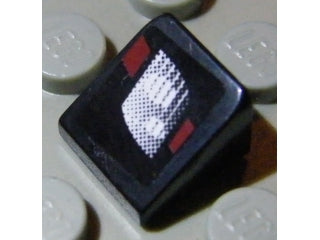 Black LEGO 1x1x2/3 slope brick with a white dotted rectangular headlight pattern and small red accents on a light background.