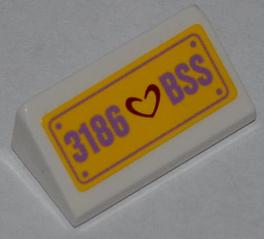 White LEGO slope brick with yellow license plate pattern, purple '3186 ❤️ BSS' text, and a dark red heart.