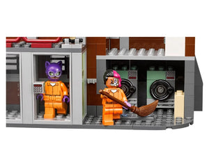 LEGO Arkham Asylum set with Catwoman and Two-Face minifigures in orange prison jumpsuits, with cells and safe doors.