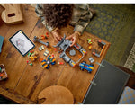 Child assembling LEGO Super Mario Bowser's Castle and other sets, including a kart and figures, following tablet instructions.