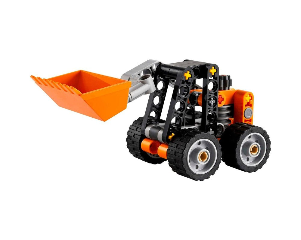 LEGO Technic 30710 Skid-Steer Loader, a small black and orange model with an orange front bucket, on a white background.