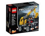 LEGO Technic 42031 Cherry Picker set box featuring a built yellow and black cherry picker model against a dark urban background.