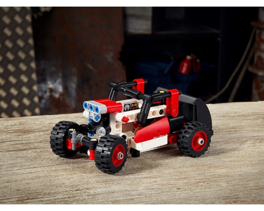 Red and white LEGO Technic 42116 alternate buggy build on a wooden table.