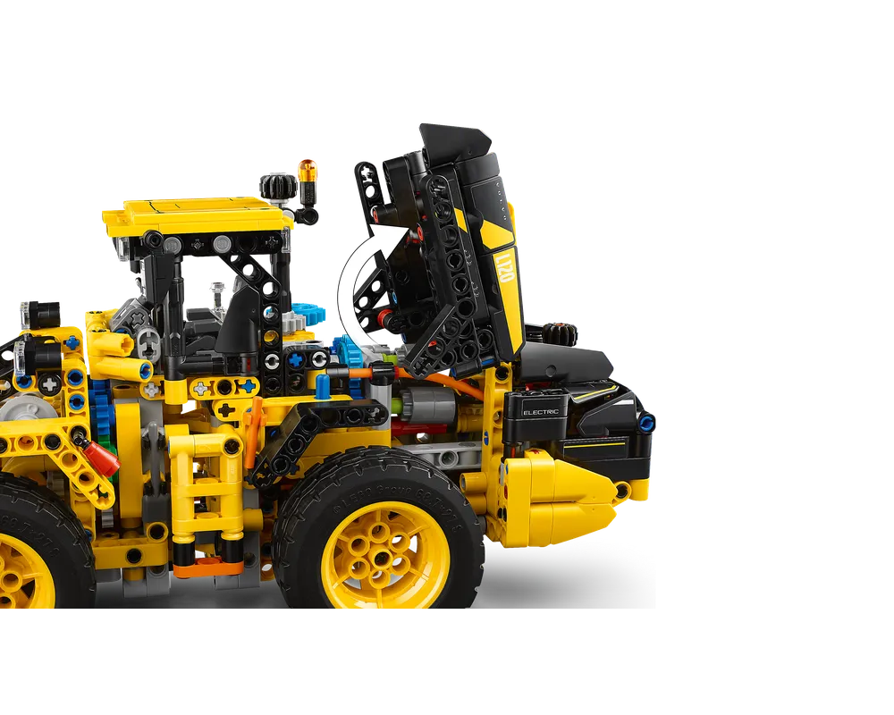Close-up of LEGO Technic 42209 Volvo L120 Electric Wheel Loader with engine cover open, showing internal details and yellow wheels.