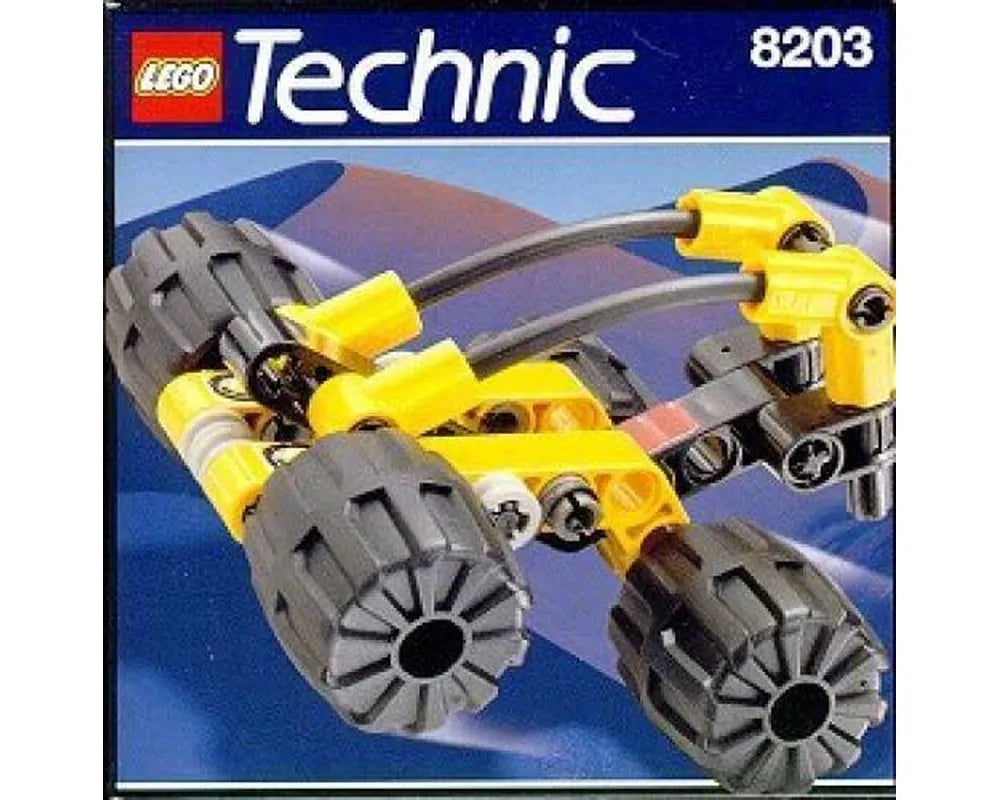 LEGO Technic 8203 Rover Discovery set, a compact yellow and dark grey vehicle with large wheels on a blue background.