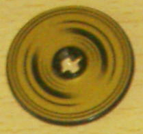 LEGO Technic 3x3 disk with black half-circle rings forming a spiral pattern on a gold background, with a central hole.