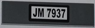 Dark gray LEGO 1x4 tile with white sticker featuring black text 'JM 7937'.