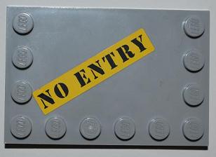 Grey LEGO 4x6 tile with studs on edges, featuring a yellow sticker with black 'NO ENTRY' text.