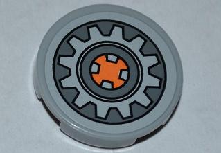 LEGO 4150pb104 - Tile, Round 2 x 2 with Gear Wheel with Orange Center on Dark Bluish Gray Background Pattern (Sticker) - Set 9444