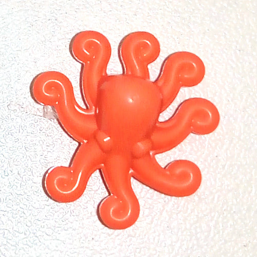 Bright orange plastic octopus toy accessory with eight curled tentacles on a white textured background.